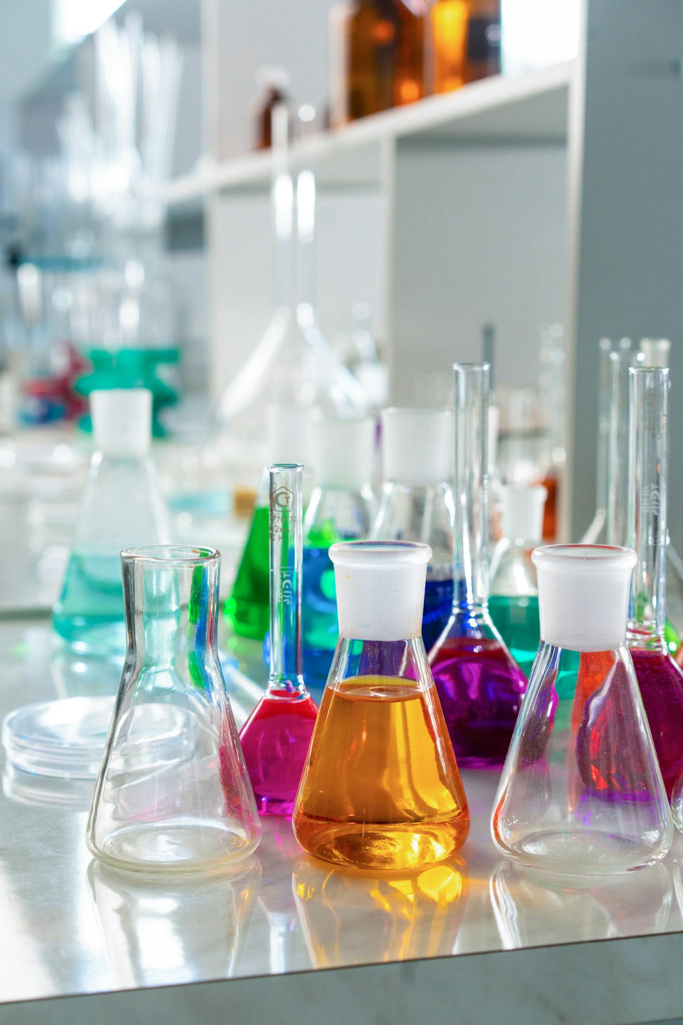Vibrant glassware with colored solutions in a well-lit laboratory setting.